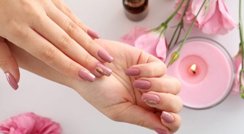 Concept of hand care with cosmetics on white background